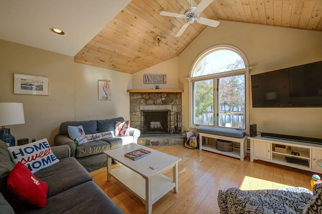 living room featuring wood-type flooring, a fireplace, a ceiling fan, and wood ceiling