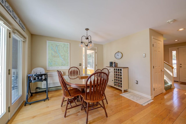 dining area with recessed lighting, baseboards, a chandelier, and light wood-style floors