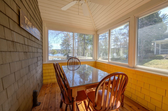 sunroom / solarium with hardwood / wood-style flooring and a healthy amount of sunlight