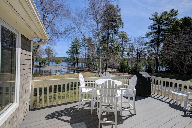 deck featuring area for grilling and a water view