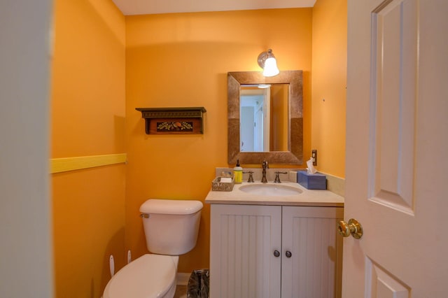 bathroom featuring toilet and vanity
