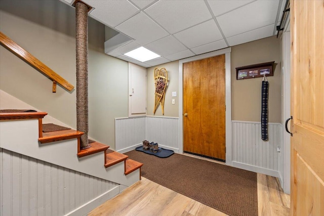 374 Youngs Ridge Rd, Acton, ME 04001 - entryway with wood finished floors, a wainscoted wall, stairway, and a paneled ceiling