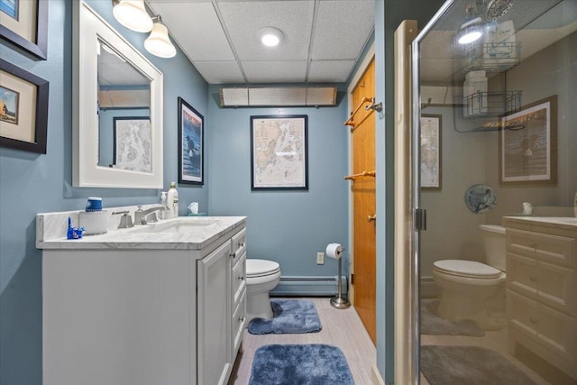 374 Youngs Ridge Rd, Acton, ME 04001 - full bathroom with toilet, a baseboard radiator, a shower with shower door, vanity, and a drop ceiling
