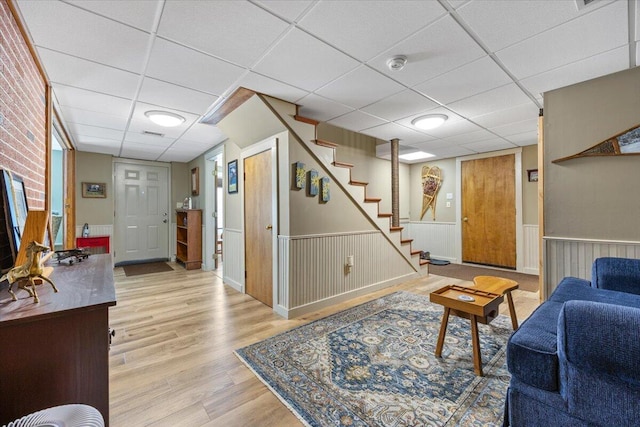 374 Youngs Ridge Rd, Acton, ME 04001 - living area with a drop ceiling, stairs, wood finished floors, and a wainscoted wall