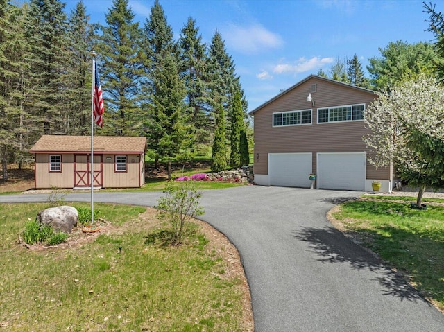 374 Youngs Ridge Rd, Acton, ME 04001 - view of front facade featuring a garage, asphalt driveway, and an outdoor structure