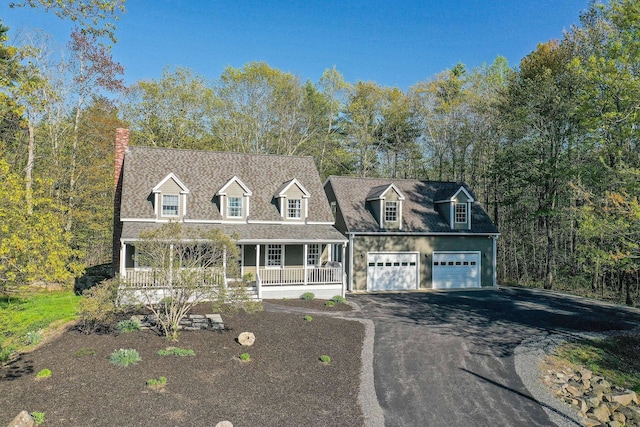 72 Natures Way, Wells, ME 04090 - cape cod house with covered porch, asphalt driveway, and a chimney