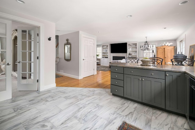 72 Natures Way, Wells, ME 04090 - kitchen with a chandelier, a fireplace, gray cabinets, open floor plan, and baseboards