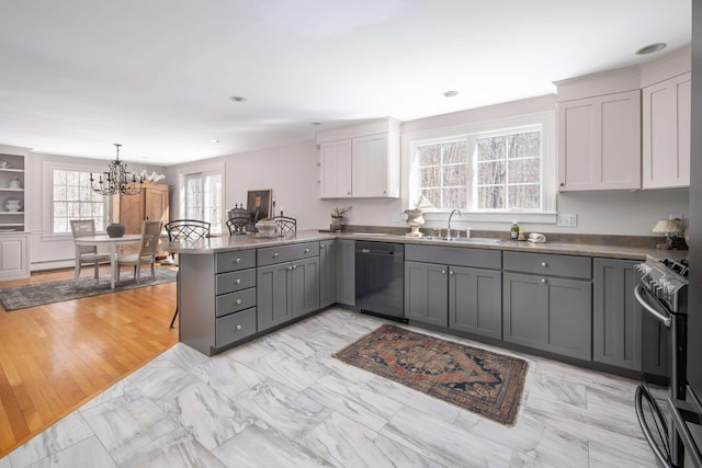 72 Natures Way, Wells, ME 04090 - kitchen featuring appliances with stainless steel finishes, gray cabinetry, a sink, a peninsula, and a chandelier