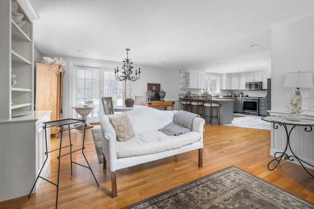 72 Natures Way, Wells, ME 04090 - living room featuring light wood-style flooring, a chandelier, and recessed lighting