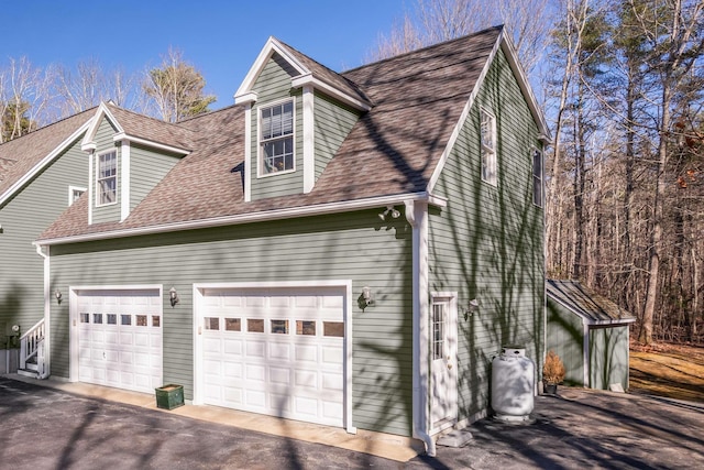 72 Natures Way, Wells, ME 04090 - view of home's exterior with driveway, a shingled roof, and an attached garage