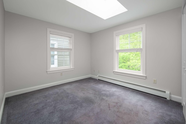 72 Natures Way, Wells, ME 04090 - unfurnished room with baseboard heating, a skylight, dark colored carpet, and baseboards