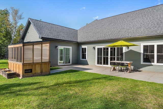 back of house with a patio area, a yard, and a shingled roof