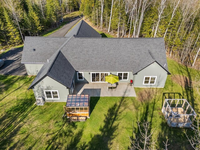 view of subject property with a heavily wooded area