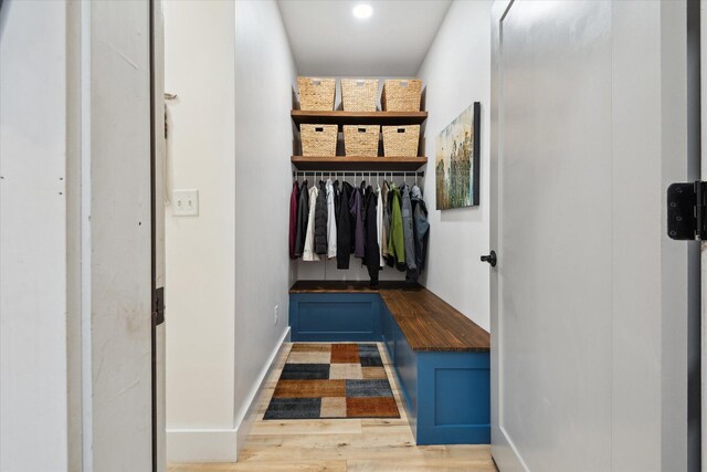 mudroom featuring wood finished floors and baseboards