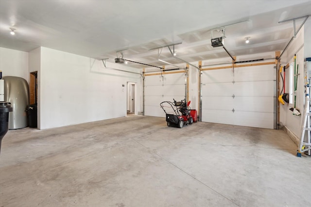 garage with a garage door opener and water heater