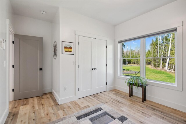 foyer featuring light wood-type flooring and baseboards