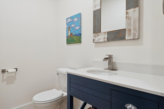 bathroom with toilet and vanity