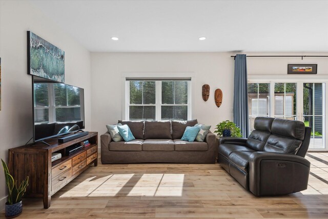 living area featuring light wood finished floors and recessed lighting