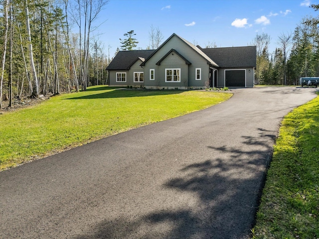 ranch-style home featuring a garage, driveway, and a front lawn