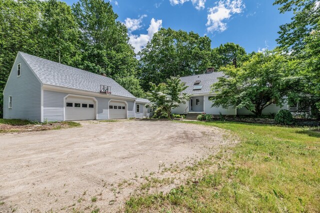 29 Penny Ln, Blue Hill, ME 04614 - view of front of property featuring a shingled roof, driveway, entry steps, and a chimney