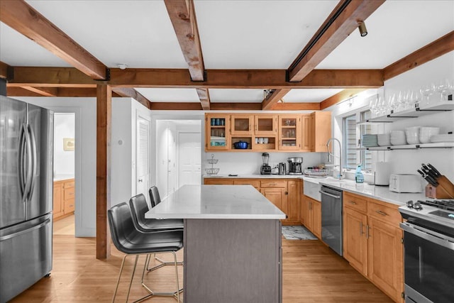 29 Penny Ln, Blue Hill, ME 04614 - kitchen with a breakfast bar, appliances with stainless steel finishes, a center island, glass insert cabinets, and light wood-type flooring