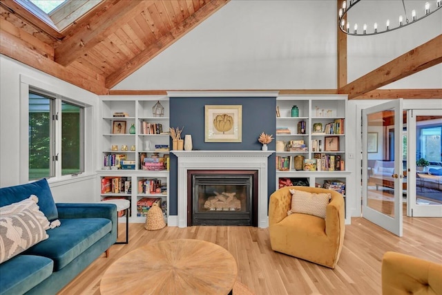 29 Penny Ln, Blue Hill, ME 04614 - living area with wooden ceiling, a glass covered fireplace, beamed ceiling, and wood finished floors