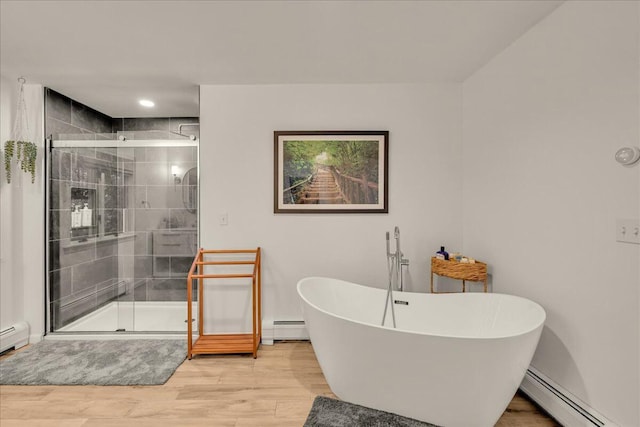 29 Penny Ln, Blue Hill, ME 04614 - bathroom featuring a shower stall, baseboard heating, wood finished floors, and a freestanding tub