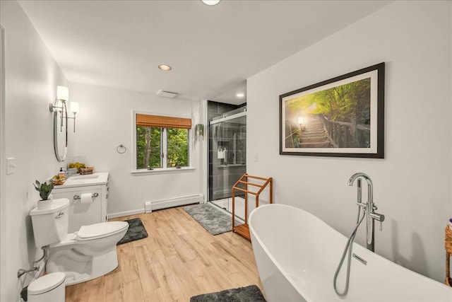 29 Penny Ln, Blue Hill, ME 04614 - bathroom with a baseboard heating unit, toilet, a shower stall, a soaking tub, and wood finished floors
