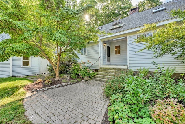 29 Penny Ln, Blue Hill, ME 04614 - property entrance with a chimney and a patio area