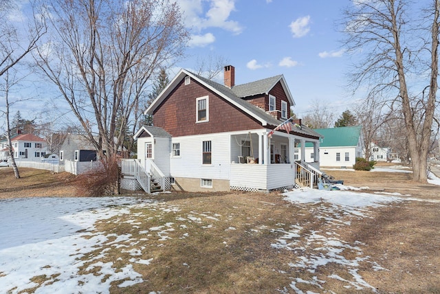 107 Portland St, Fryeburg, ME 04037 - snow covered rear of property featuring a chimney