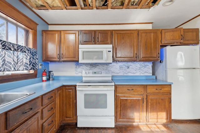 107 Portland St, Fryeburg, ME 04037 - kitchen with light countertops, brown cabinetry, and white appliances