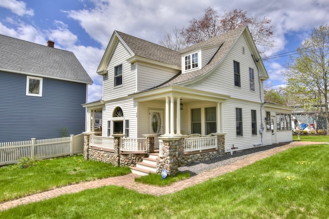 28 Saco Ave, Old Orchard Beach, ME 04064 - view of front facade featuring a shingled roof, covered porch, a front yard, and fence