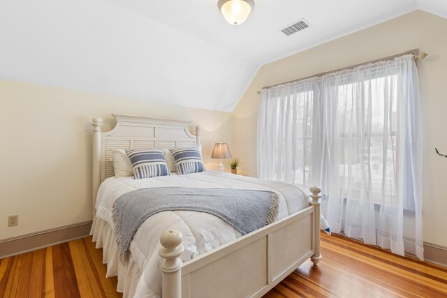 28 Saco Ave, Old Orchard Beach, ME 04064 - bedroom featuring visible vents, baseboards, vaulted ceiling, and wood finished floors