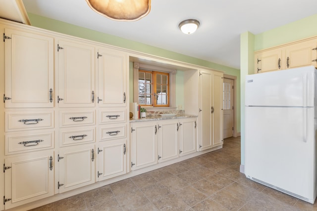 28 Saco Ave, Old Orchard Beach, ME 04064 - kitchen featuring cream cabinetry, freestanding refrigerator, and light stone counters
