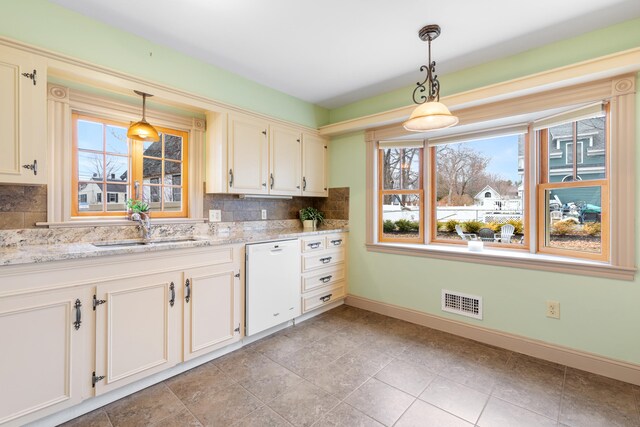 28 Saco Ave, Old Orchard Beach, ME 04064 - kitchen with tasteful backsplash, dishwasher, a sink, and baseboards