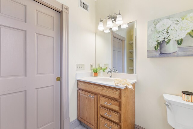 28 Saco Ave, Old Orchard Beach, ME 04064 - bathroom featuring vanity, visible vents, and toilet