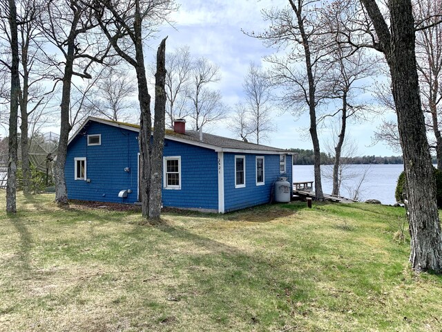21 Coyote Ln, Meddybemps, ME 04657 - view of side of home featuring a lawn, a water view, and a chimney