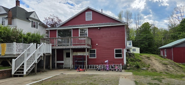 612 Franklin St, Rumford, ME 04276 - back of property with a wooden deck and stairway