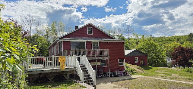 612 Franklin St, Rumford, ME 04276 - back of property featuring a deck, a chimney, a yard, and stairs