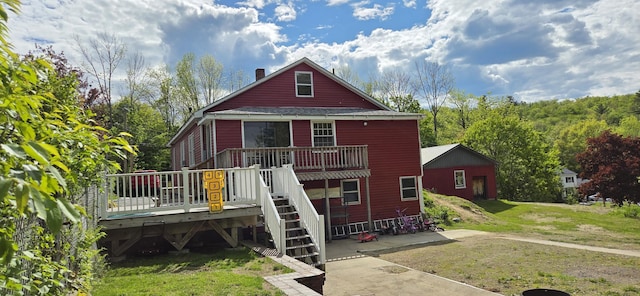 612 Franklin St, Rumford, ME 04276 - rear view of property with a deck, a chimney, a lawn, and stairway