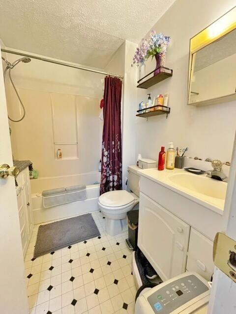 160 Washington Ave, Portland, ME 04101 - bathroom with a textured ceiling, shower / bath combo, toilet, and vanity