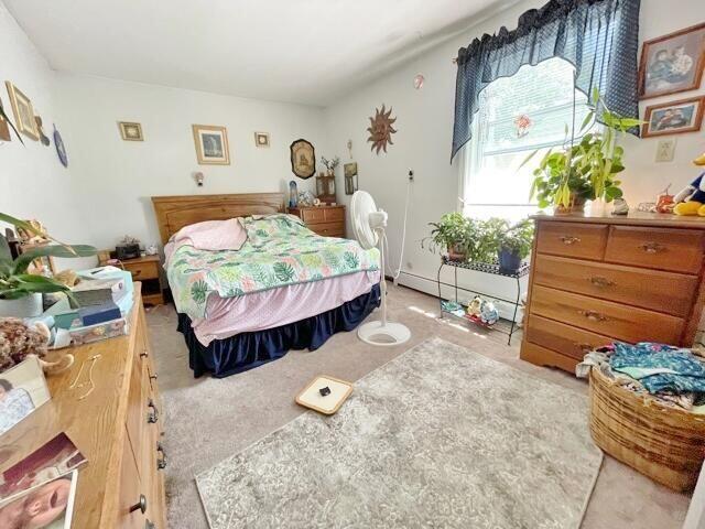 160 Washington Ave, Portland, ME 04101 - bedroom featuring a baseboard radiator and light colored carpet