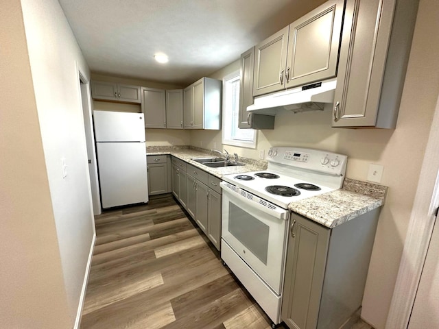 160 Washington Ave, Portland, ME 04101 - kitchen with white appliances, under cabinet range hood, gray cabinetry, a sink, and light countertops