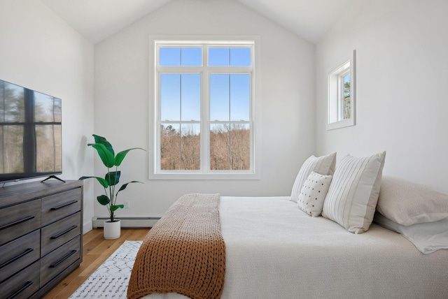 68 Green Acres Dr, Buxton, ME 04093 - bedroom with vaulted ceiling, a baseboard heating unit, and light wood-style floors