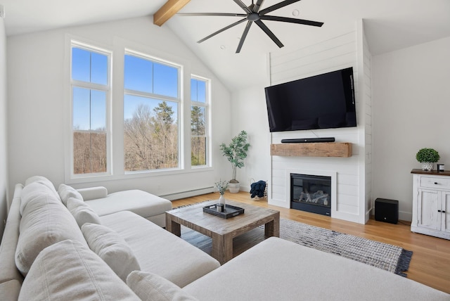 68 Green Acres Dr, Buxton, ME 04093 - living area with ceiling fan, baseboard heating, a fireplace, beamed ceiling, and light wood finished floors