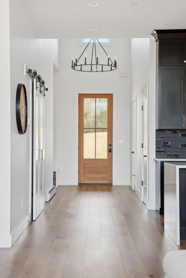 68 Green Acres Dr, Buxton, ME 04093 - doorway to outside with a chandelier, a baseboard radiator, and baseboards