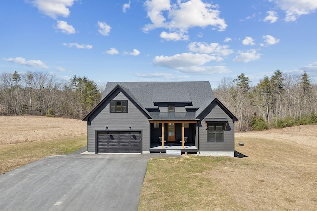 68 Green Acres Dr, Buxton, ME 04093 - modern farmhouse style home featuring a porch, an attached garage, metal roof, aphalt driveway, and a front lawn