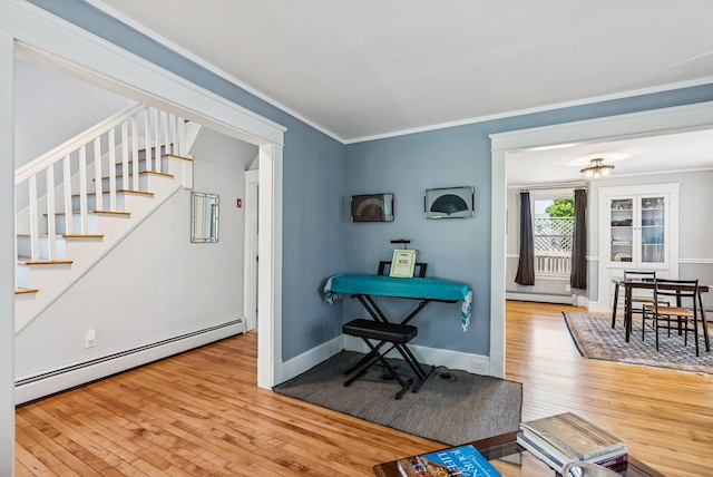 53 Ocean View Ave, South Portland, ME 04106 - living area featuring baseboard heating, hardwood / wood-style floors, stairway, and crown molding