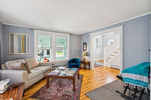 53 Ocean View Ave, South Portland, ME 04106 - living area with a baseboard heating unit, wood finished floors, ornamental molding, and stairs