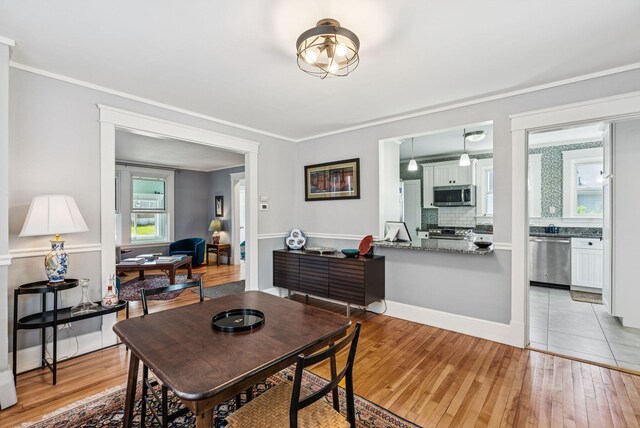53 Ocean View Ave, South Portland, ME 04106 - dining area with light wood-type flooring and ornamental molding